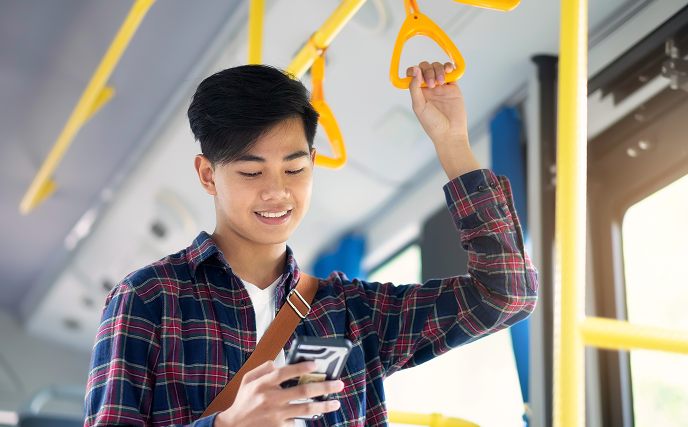 Passenger using mobile phone on public bus